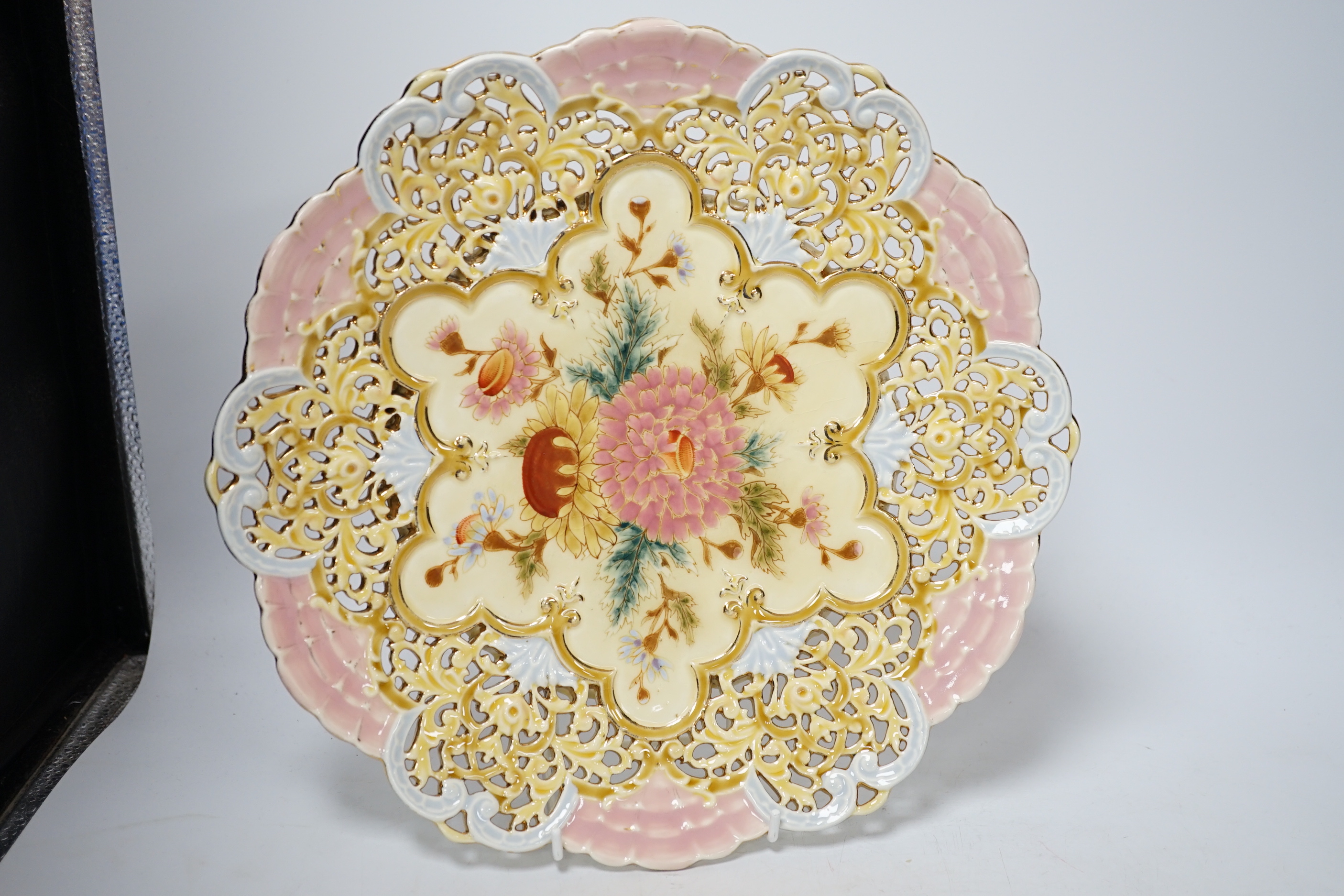 A pair of Zsolnay pierced floral and gilt decorated dishes, 31cm high